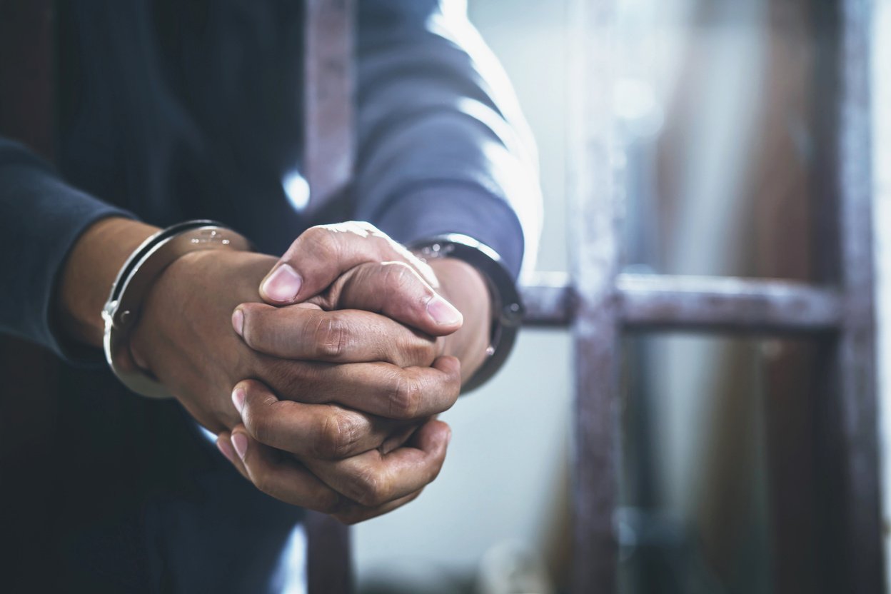 Prisoner with Handcuffs in Jail